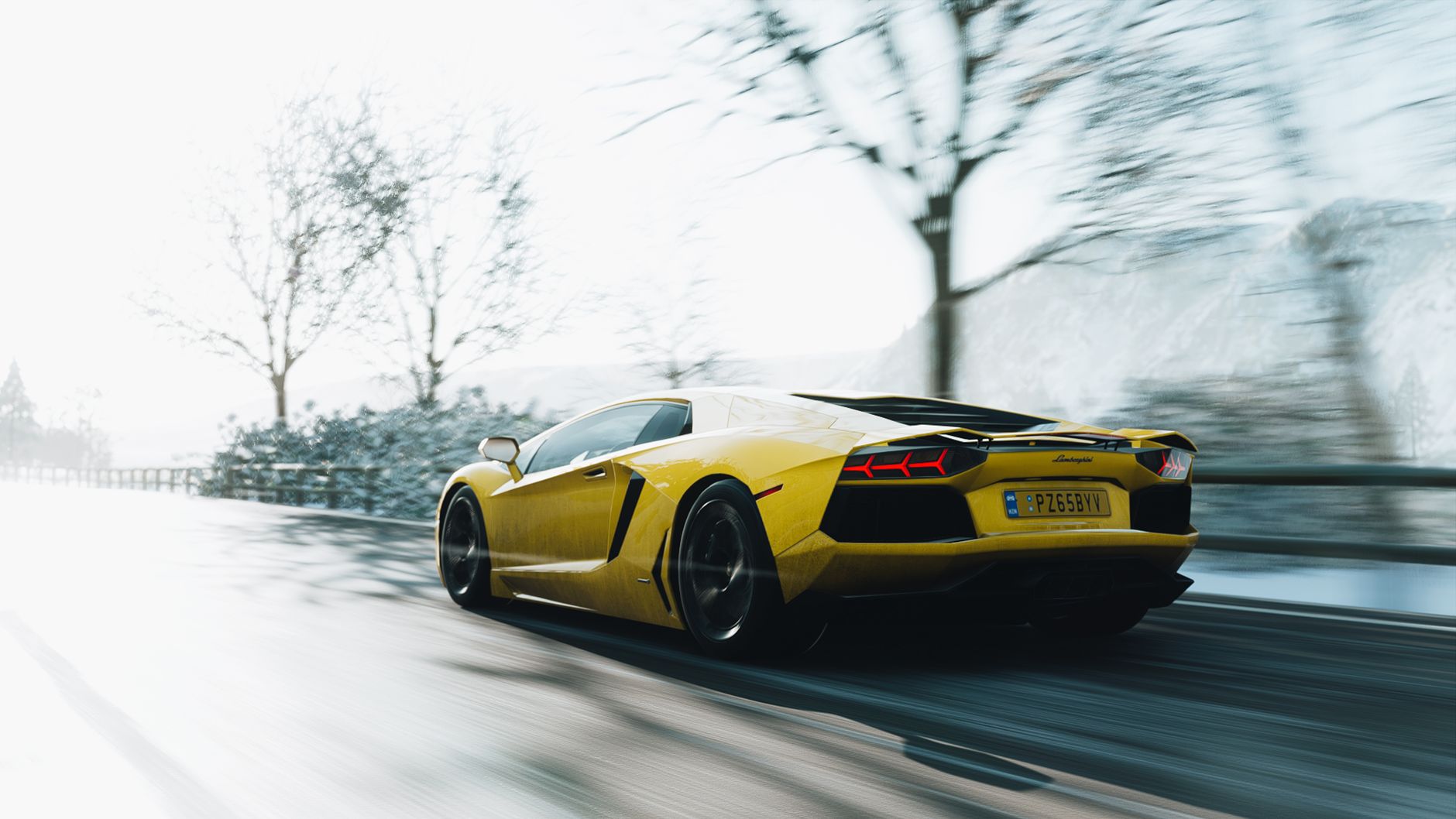 A sleek yellow Lamborghini Aventador races down a wintry road, blending speed and elegance.