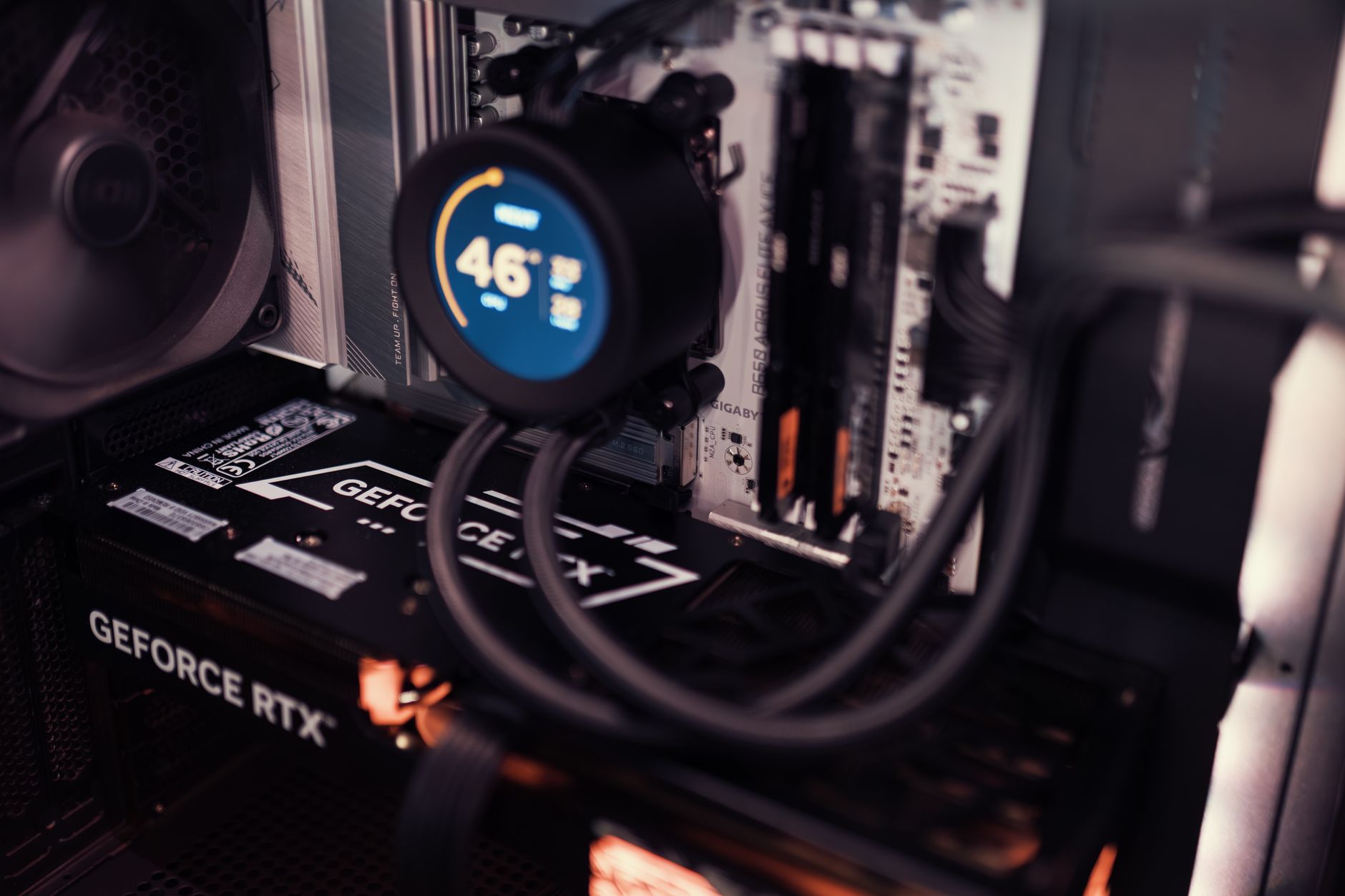 Close-up of a gaming PC interior featuring a GeForce RTX graphics card and cooling system.