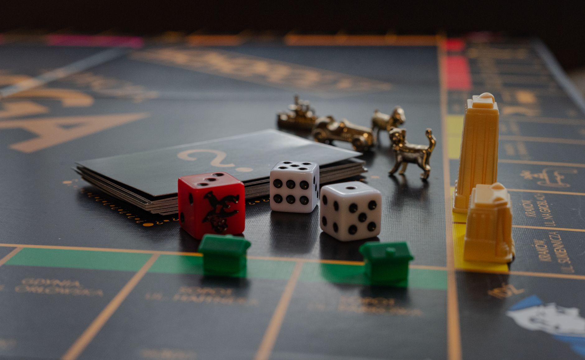 A detailed view of a board game with dice, tokens, and landmarks on a playing board.