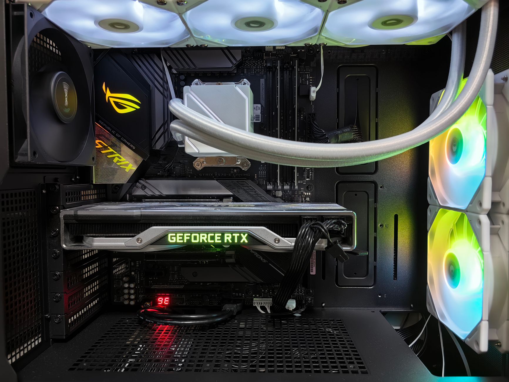 Detailed view of a gaming PC build featuring a GeForce RTX graphics card and RGB lighting in a sleek black case.