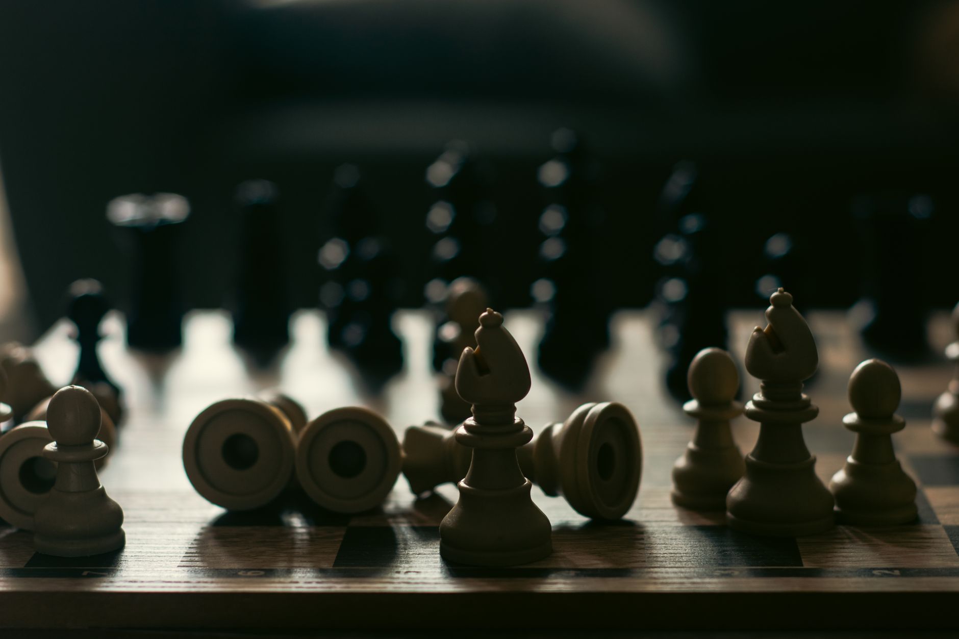 A dramatic representation of strategy and competition with chess pieces on a board.
