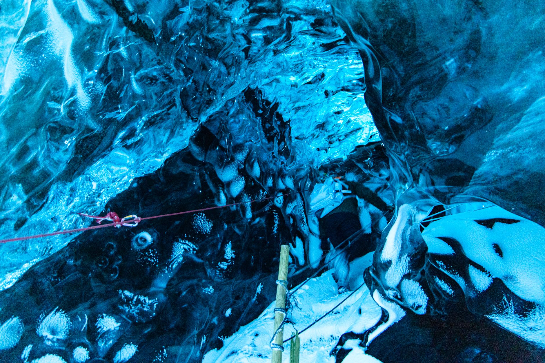 Explore the stunning blue hues of an intricate ice cave formation.