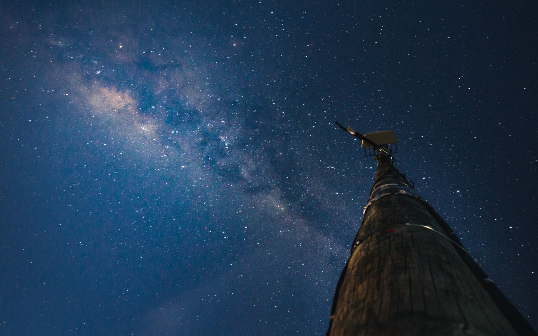 A dramatic view of the Milky Way galaxy with a communication pole in Wanaka, New Zealand.